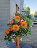 A large tombstone with red and orange chrysanthemum