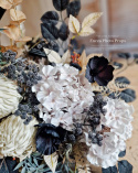 Tombstone decoration in a basket with black poppies and hydrangea and artichokes